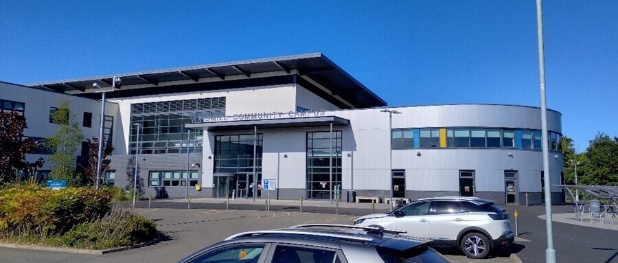 the exterior of Levenmouth Academy, a modern building with a mix of dark brick and large glass windows the exterior of Levenmouth Academy, a modern building with a mix of dark brick and large glass windows